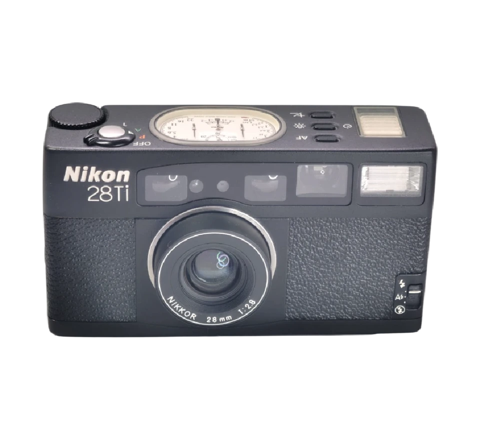Nikon 28Ti — compacta de titanio con panel de agujas analógico, años 90