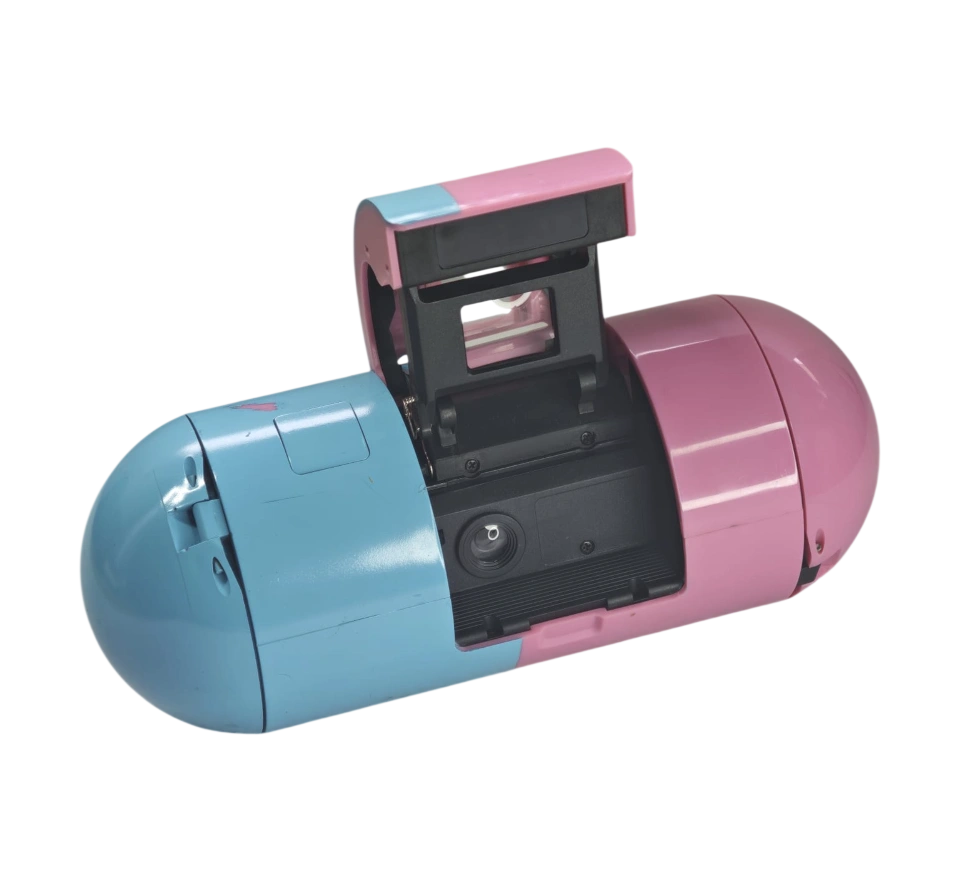 Spormadox — cámara promocional de 35mm con forma de cápsula farmacéutica, Laboratorios Dr. Esteve Barcelona